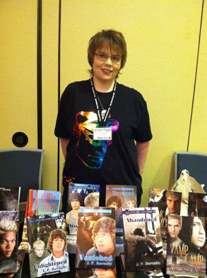 J. P. Barnaby with her books set up at OutlantaCon in Atlanta